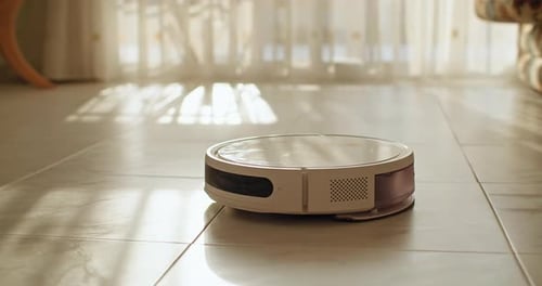 Robotic Vacuum Cleans Tile Floor in Sunny Room