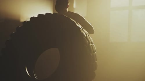 Man flipping a big heavy tire