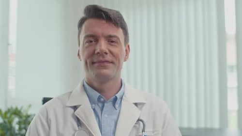 Friendly Male Doctor Smiling in Bright Office