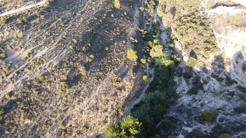 Aerial over rough dry vegetation terrain, rural countryside Spain land