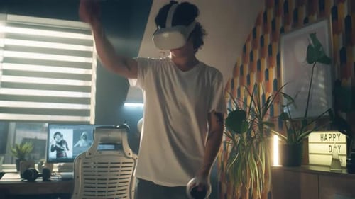 Teen Using VR Headset and Controllers