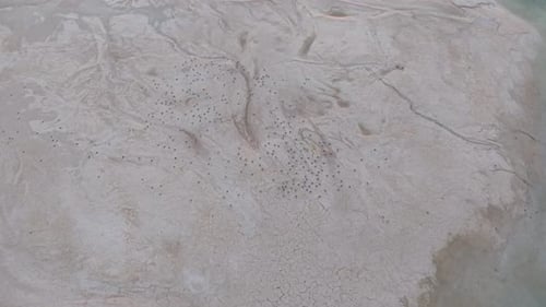 Aerial drone view of cracked desert terrain with dry textures and arid patterns