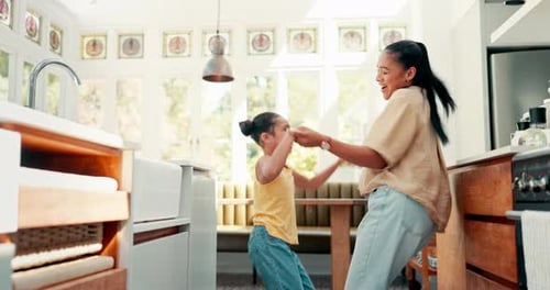 Mother and Child Dancing in Modern Kitchen