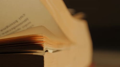 Old book flipping pages. 4k resolution.