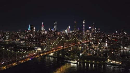 Aerial Views of Illuminated Queensboro Bridge and New York City Skyline Highlight Vibrant Lights