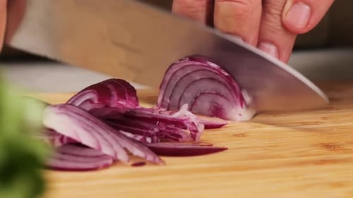Slicing Red Onion on Cutting Board