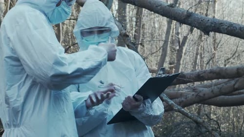 Forensic Specialist Working in the Forest Police Criminalists Collecting Evidence and Making