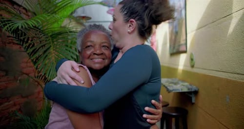 Two Women Embracing Affectionately in an Outdoor Space