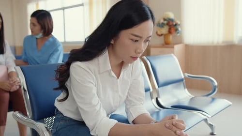 girl sitting on chair waiting room feel scary for bad news stress hopeless and sadness.