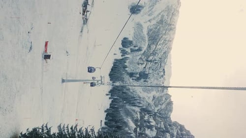 Cable cars in mountains, view from cabin. Vertical video
