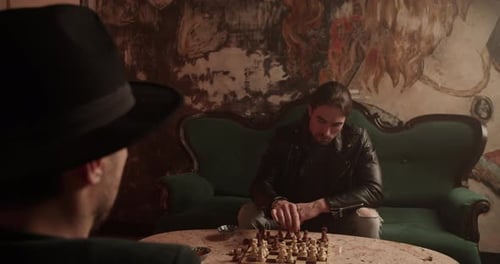Adults Playing Chess in a Dimly Lit Room