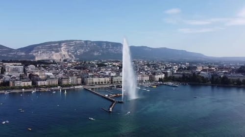Órbita aérea ao redor da fonte de água Jet d'Eau, Lago de Genebra - Dia ensolarado