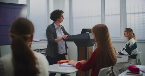 Female Educator in Computer Programming Class Presents Software Code on Smartboard