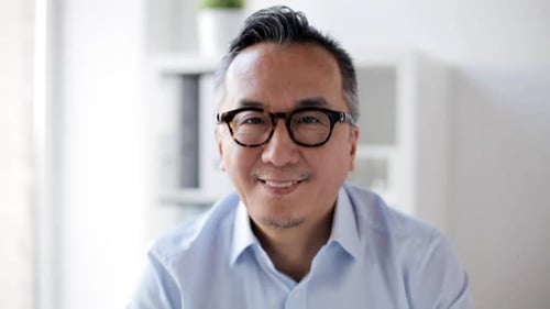 Happy Asian Businessman Smiling at Office