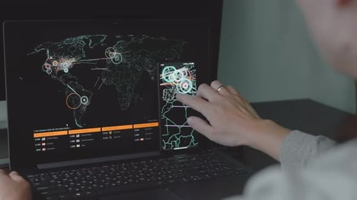 Woman Interacting With Data on Laptop and Smartphone