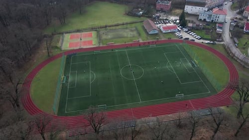 Aerial View of Stadium in Small Town Players Play Football on Soccer Field