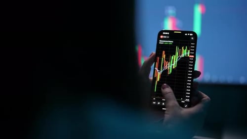 Professional Female Trader Analyzing Bond Market Investments on Smartphone with Display Chart of