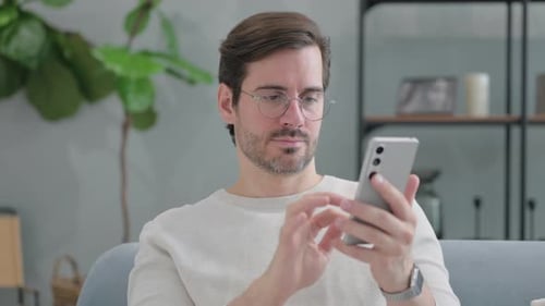 Man Using Smartphone Indoors Close Up