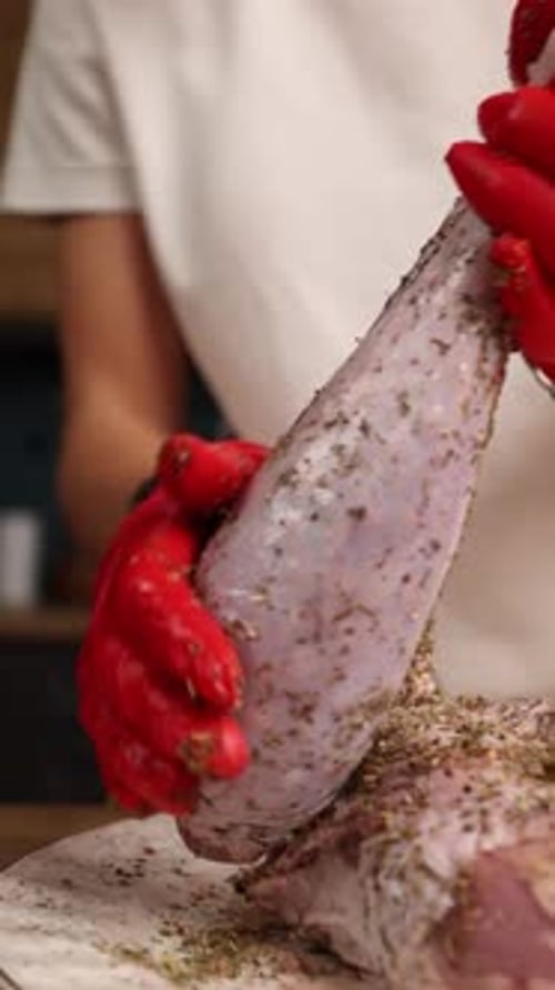 The chef prepares a dish of meat in the kitchen. Close-up