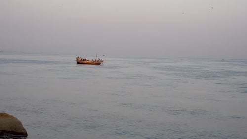 Boat on the tranquil Arabian Sea off Karachi coast at Sea View Karachi, Pakistan