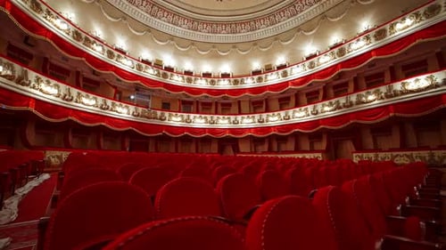 Rows with red chairs in beautiful theater hall. No audience at lockdown time.