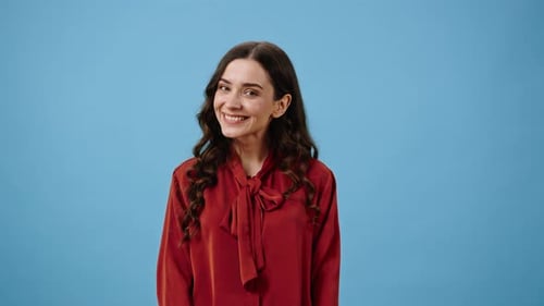 Romantic Woman Smiles Cutely and Shows Heartbeat Gesture