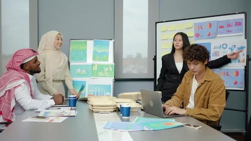 Diverse Team Collaborating on a Presentation in Office