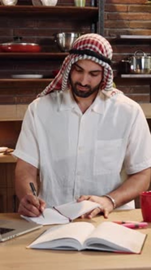 A Person in a Modern Kitchen Wearing a Headscarf Focused on Culinary Arts and Cooking