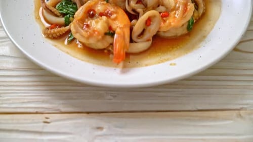 Stir-Fried Seafood with Basil on White Plate