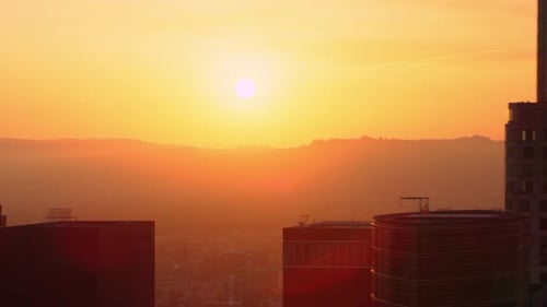 Soaring above downtown Los Angeles skyscrapers during a warm California sunset