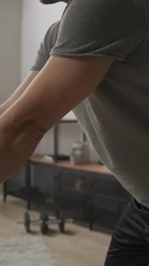 Focused Home Workout with Resistance Bands Emphasizing Strong Arm Muscles Forearm Veins and