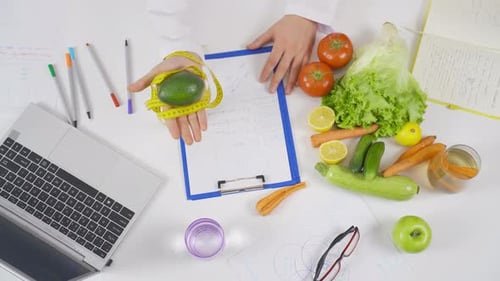 Dietician's Desk with Healthy Foods and Computer
