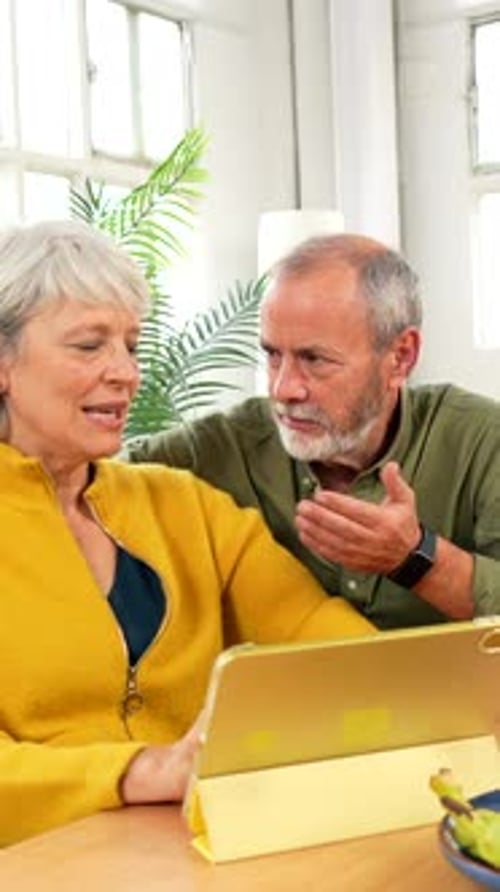 Senior Couple Using Tablet in the Morning at Home