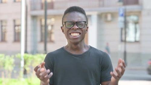 Young Adult Yelling in Frustration on City Street