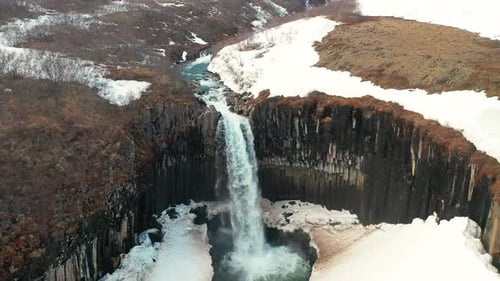 Stunning Landscape Of Svartifoss Waterfall Cascading On The River In South Iceland. - aerial drone a