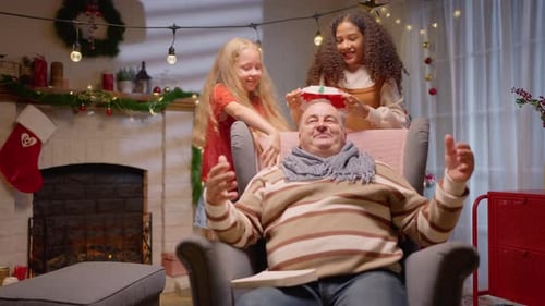 Grandfather Reading Book, Gets Christmas Surprise From Grandchildren