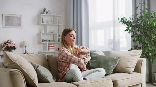 Woman Dancing on Couch in Living Room
