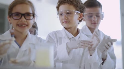 Enthusiastic Children Doing a Science Experiment in Lab