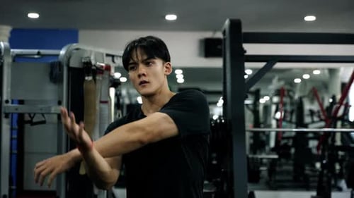 Muscular healthy man working out excwecise in gym fitness