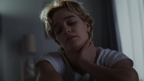 Worried Young Adult Indoors at Night