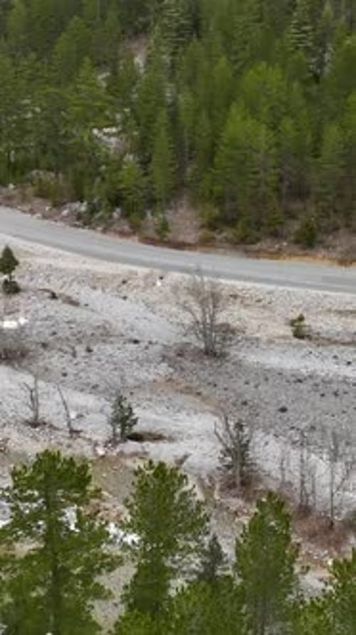 Vertical Video Aerial Paradise Cinematic Winter Mountain Forest with River and Majestic Waterfalls