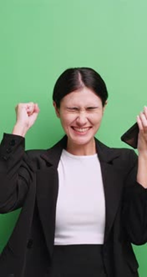 Excited Young Woman Celebrating Success on Phone