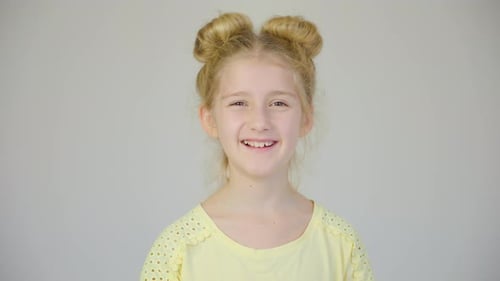 Smiling Young Girl with Blonde Hair in Studio