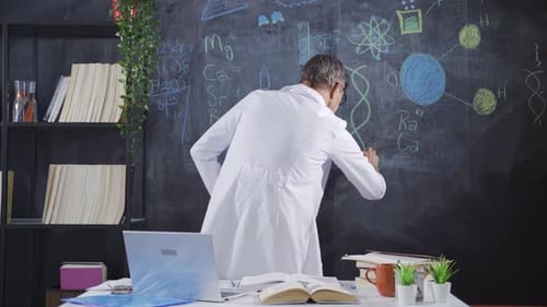 Scientist Drawing Equations on Chalkboard in Workplace