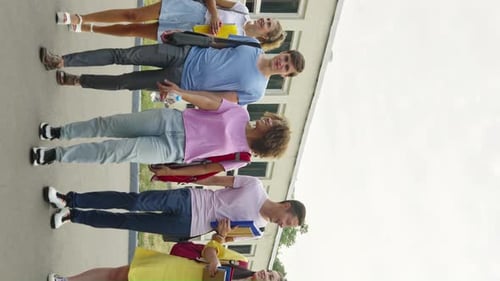 Vertical Screen Group of Diverse Students Walking Against College Building
