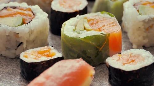 Hand Hold Chopsticks with Sushi Roll Philadelphia Roll in Sushi Set Close Up Traditional Japanese