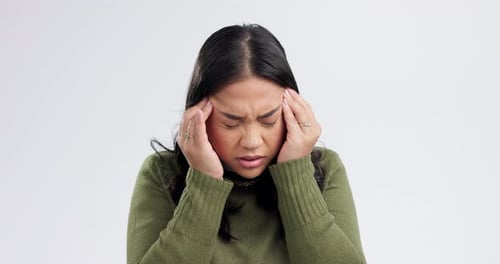 Woman, headache and pain for stress, mental health or crisis and risk and massage temple on a white