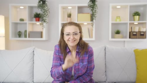 The woman waving at the camera.