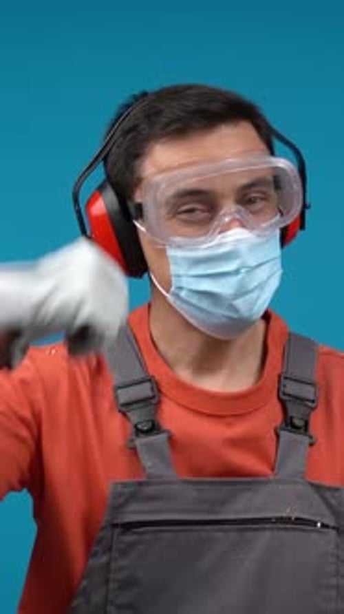 Worker in Safety Gear Gives Thumbs Up