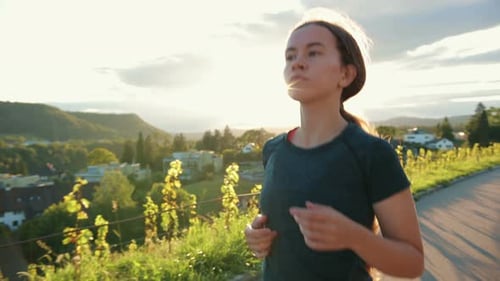 Portrait of Young Athlete Woman Running Down the Street Training Hard Getting Ready for Race